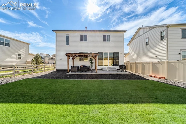 back of property with a yard, a pergola, and a patio area