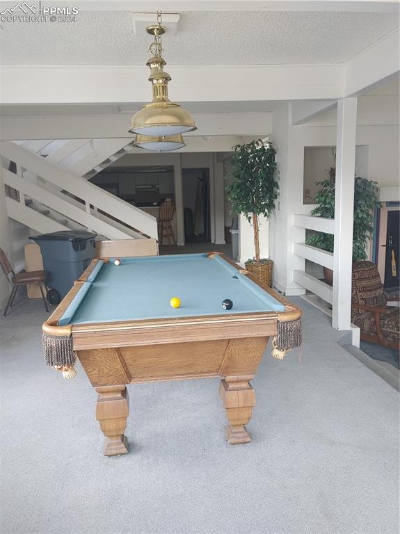 recreation room with billiards, carpet, and a textured ceiling