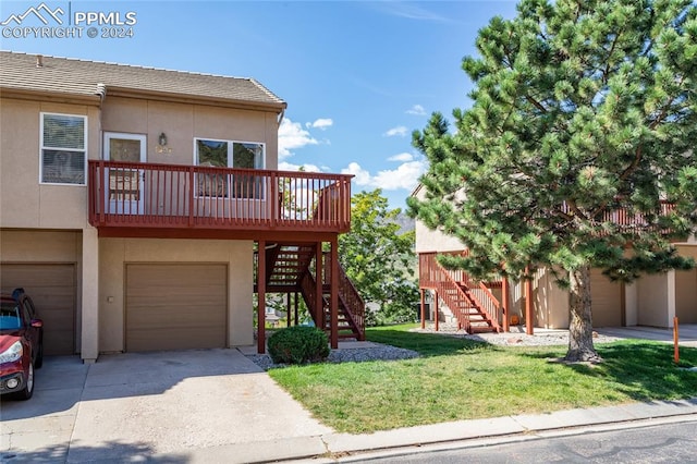 view of front facade featuring a front lawn, a deck, and a garage