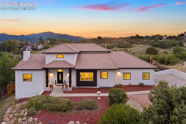 view of front of home with a mountain view and a patio