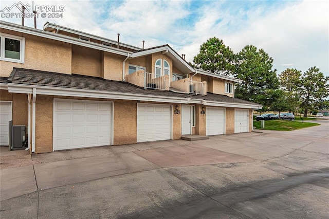 view of front of house featuring a balcony and a garage