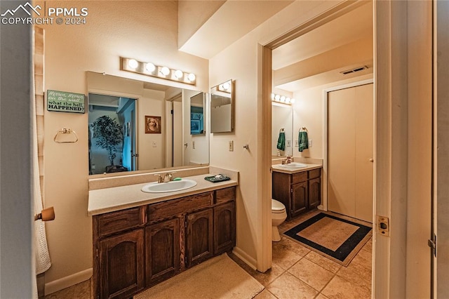 bathroom featuring tile patterned floors, toilet, and vanity