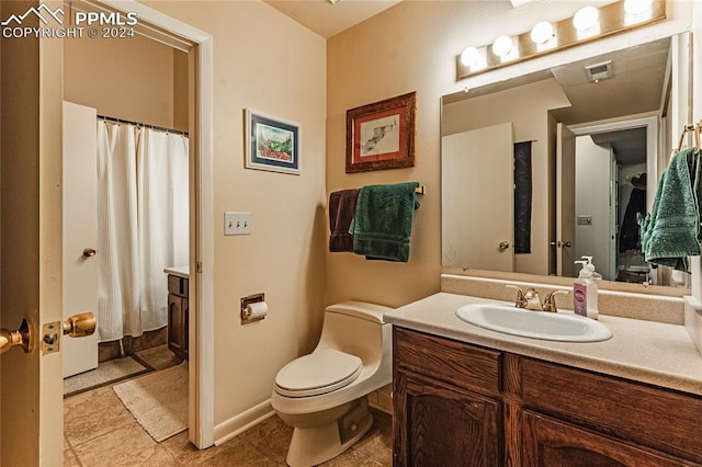 bathroom with vanity, toilet, and tile patterned floors