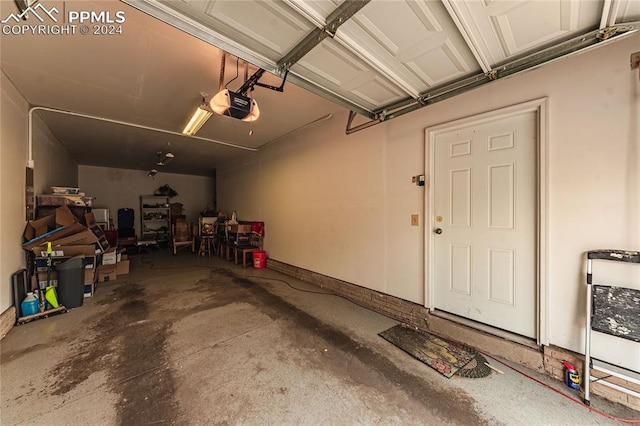 garage featuring heating unit and a garage door opener