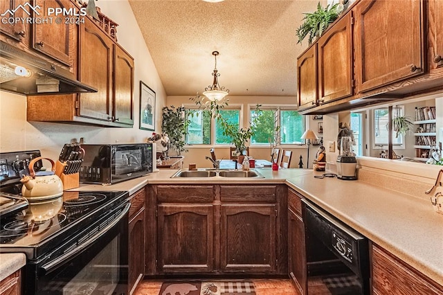 kitchen with hanging light fixtures, sink, black appliances, kitchen peninsula, and a textured ceiling