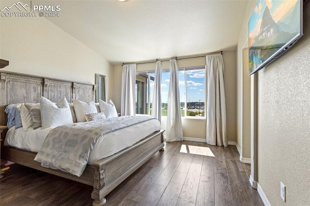 bedroom with dark hardwood / wood-style flooring and vaulted ceiling