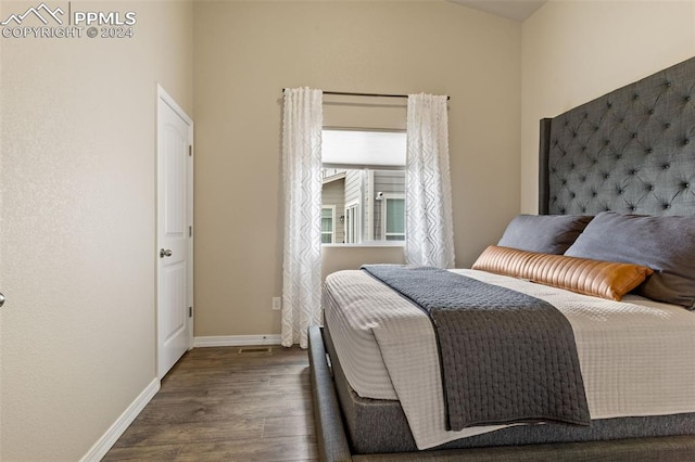 bedroom with dark wood-type flooring