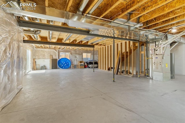 basement with water heater and heating unit