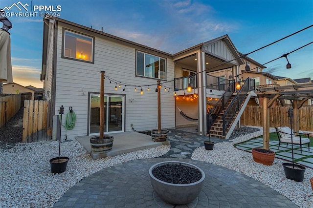 back house at dusk with a patio area