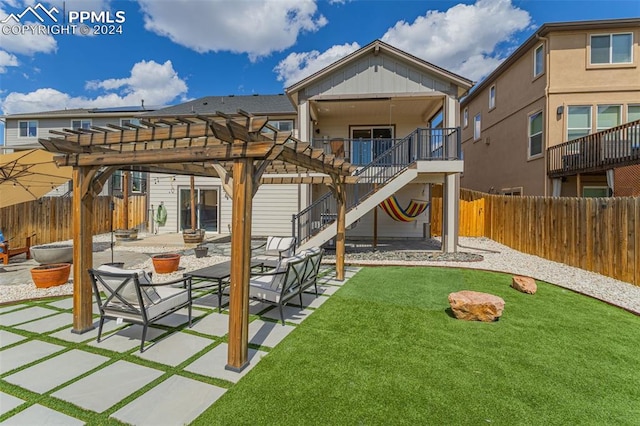 rear view of property featuring a pergola, a patio area, and a yard