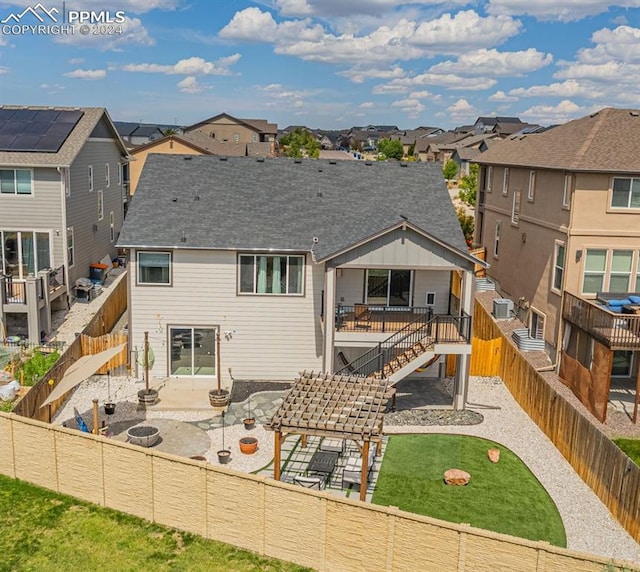 back of property with a patio area and a yard