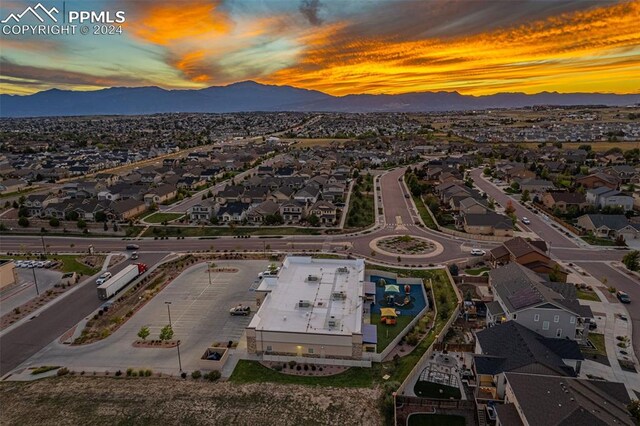 aerial view at dusk featuring a mountain view