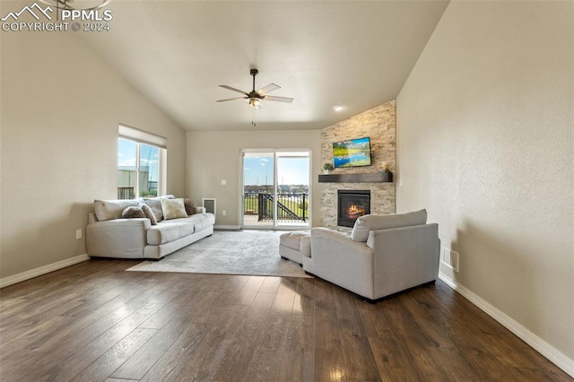 living room with ceiling fan, vaulted ceiling, a fireplace, and dark hardwood / wood-style flooring