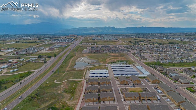 birds eye view of property with a water and mountain view