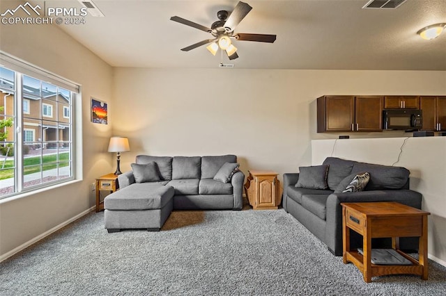 living room featuring ceiling fan and carpet floors