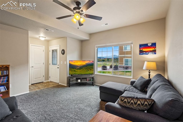 carpeted living room featuring ceiling fan