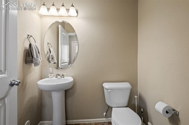 bathroom with toilet and sink