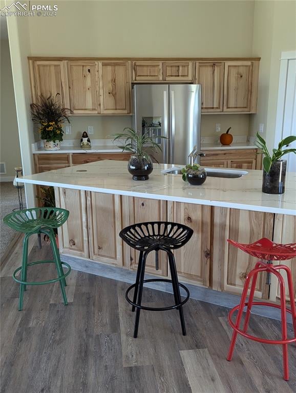 kitchen featuring light countertops, dark wood-type flooring, and stainless steel fridge with ice dispenser