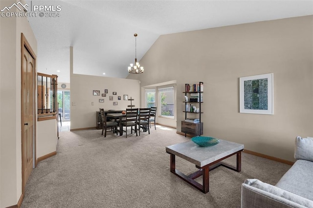 living room with a notable chandelier, high vaulted ceiling, and light carpet