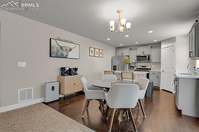 dining room with a chandelier, dark hardwood / wood-style floors, and sink