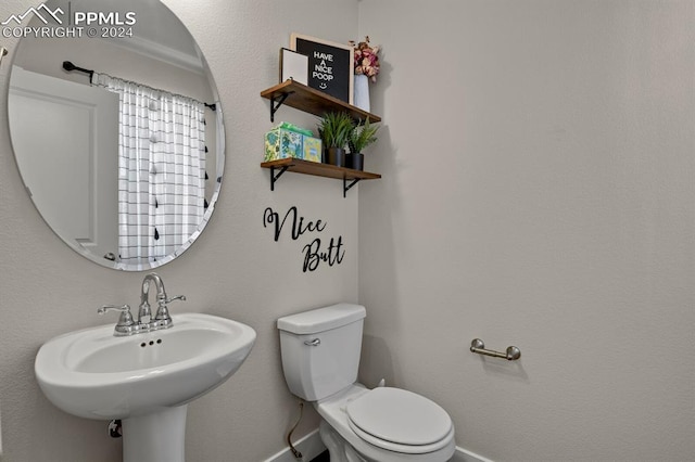 bathroom featuring sink and toilet