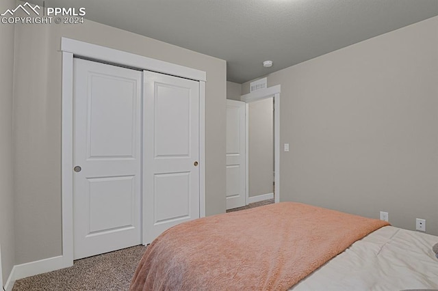 carpeted bedroom with a closet