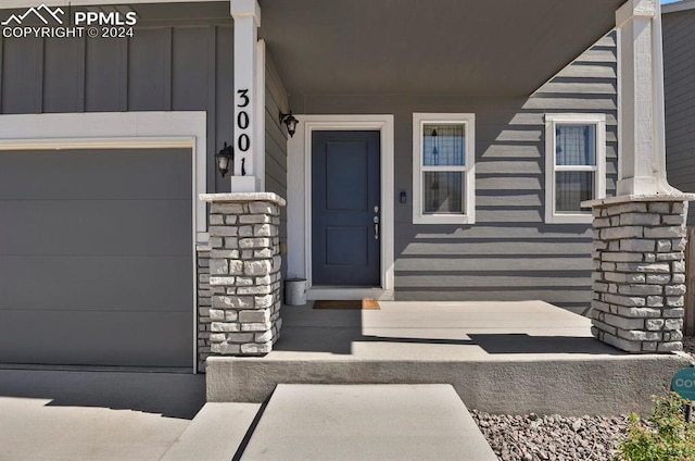 doorway to property with a garage