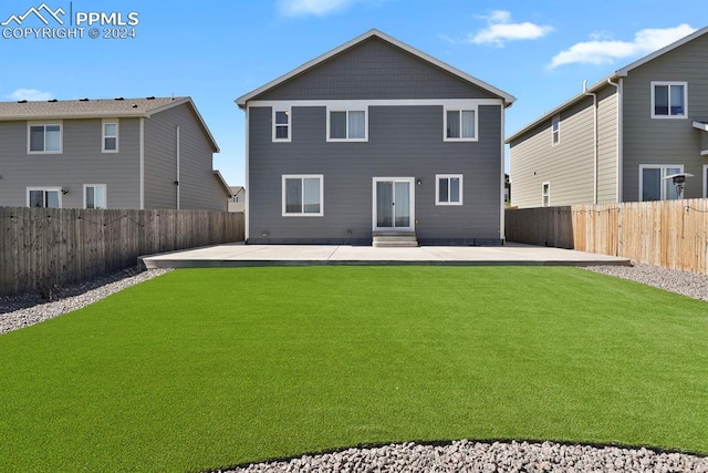 back of house featuring a yard and a patio