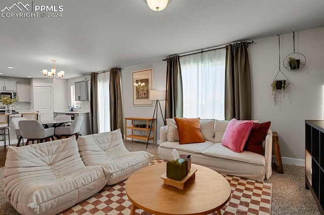 living room with a notable chandelier and light colored carpet