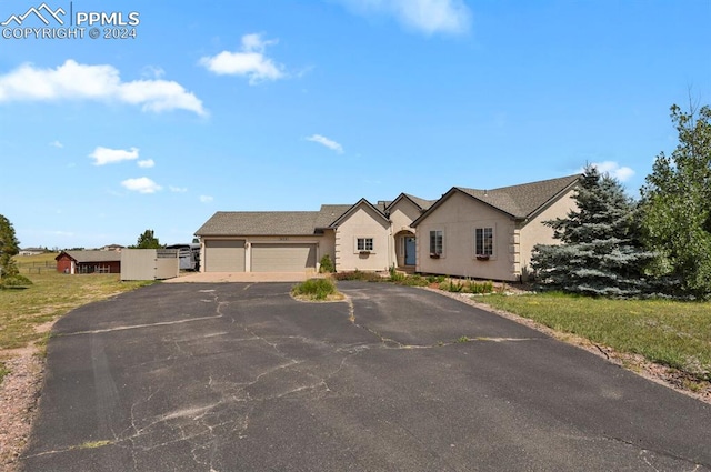 ranch-style home featuring a garage