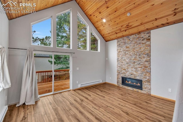 unfurnished living room featuring a baseboard radiator, a stone fireplace, hardwood / wood-style floors, wood ceiling, and high vaulted ceiling