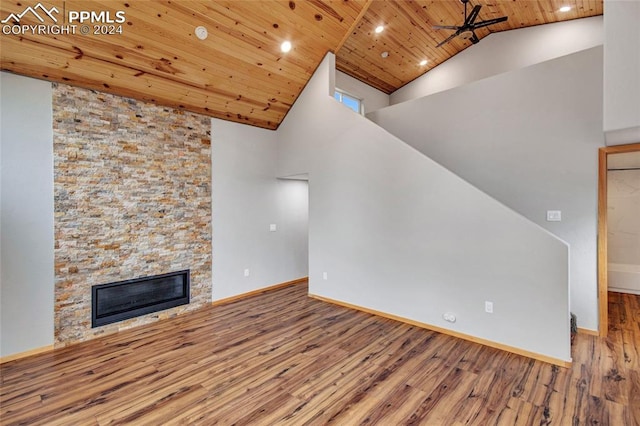 unfurnished living room with a fireplace, high vaulted ceiling, ceiling fan, wooden ceiling, and hardwood / wood-style flooring