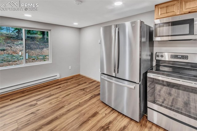 kitchen with light wood-type flooring, appliances with stainless steel finishes, and light brown cabinets