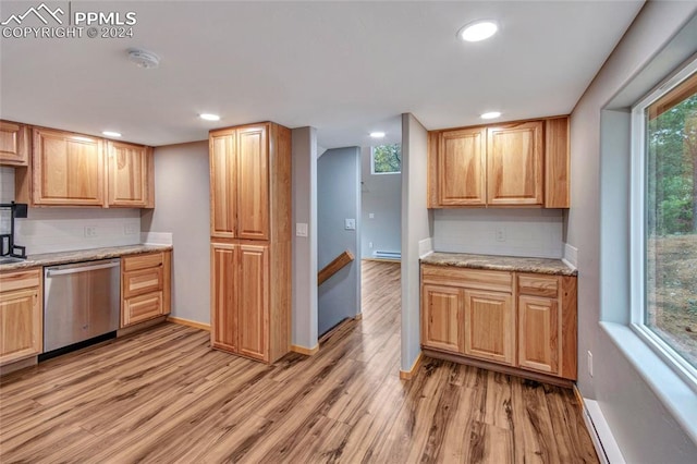 kitchen featuring stainless steel dishwasher, light stone countertops, light wood-type flooring, and decorative backsplash