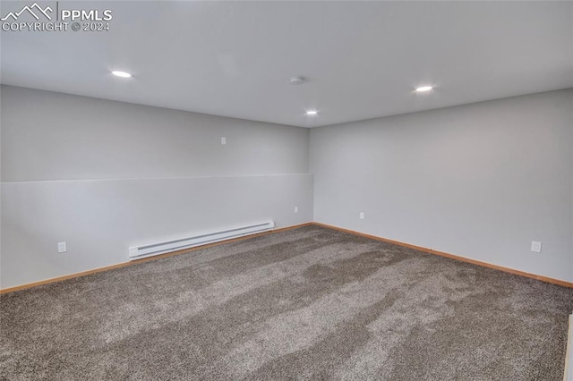 carpeted empty room with a baseboard radiator