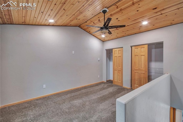 carpeted empty room featuring lofted ceiling, ceiling fan, and wooden ceiling