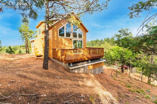 back of house with a wooden deck