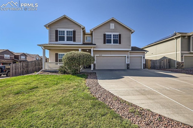 front facade featuring a garage, a porch, and a front yard