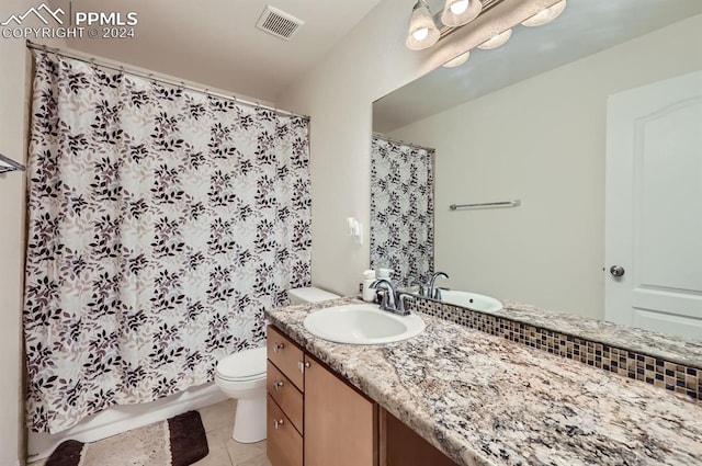 full bathroom featuring tile patterned flooring, vanity, toilet, and shower / bathtub combination with curtain