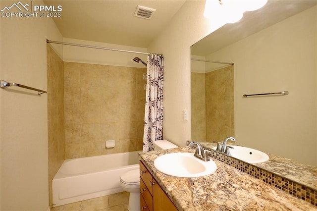 full bathroom featuring vanity, tile patterned floors, shower / bath combination with curtain, and toilet