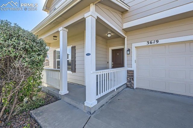 view of exterior entry with covered porch