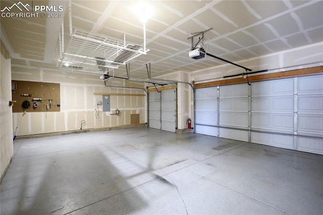 garage with a carport, a garage door opener, and electric panel