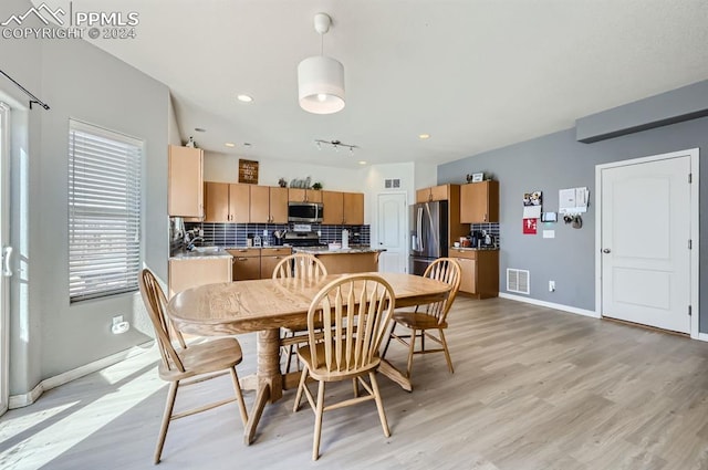 dining space featuring light hardwood / wood-style floors