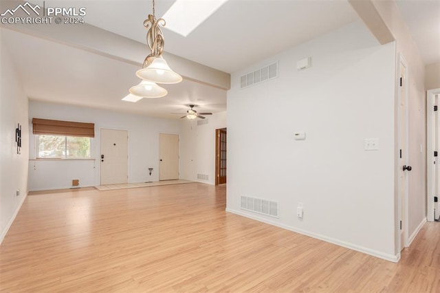 unfurnished living room featuring light hardwood / wood-style flooring and ceiling fan