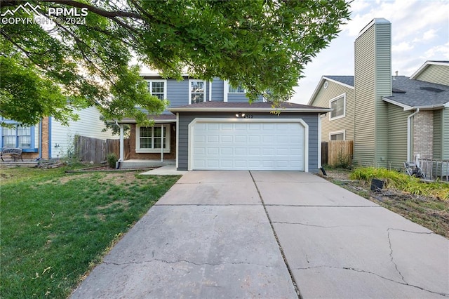 view of front property featuring a front yard and a garage