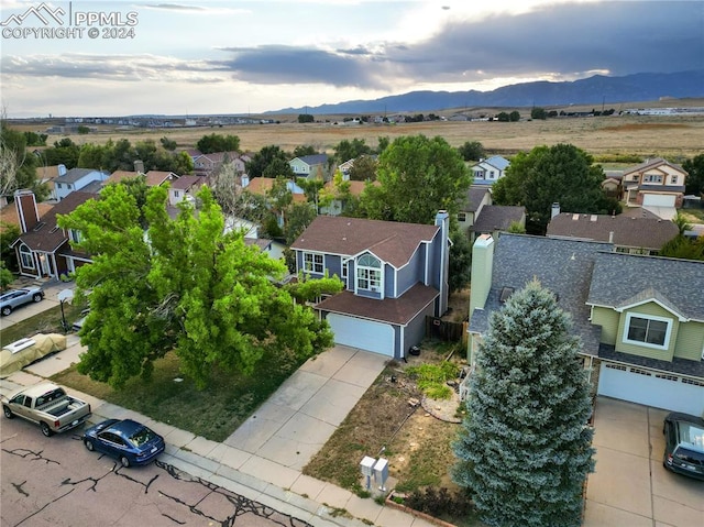 birds eye view of property with a mountain view