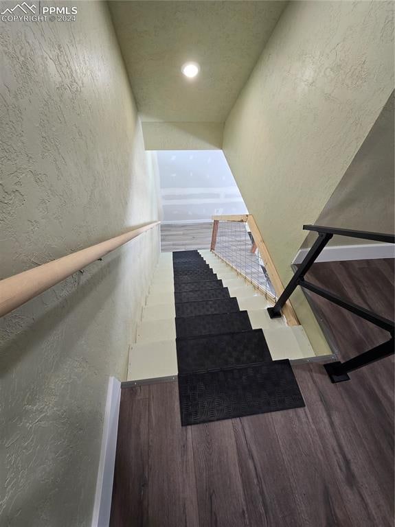 stairway with hardwood / wood-style flooring