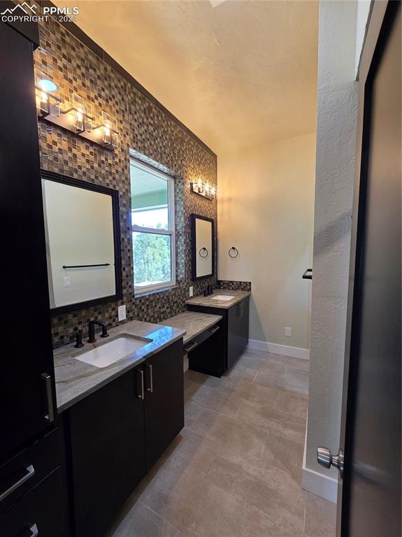 bathroom with decorative backsplash and vanity