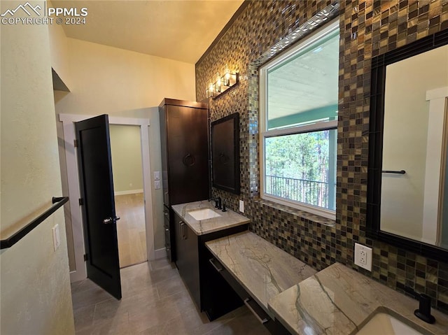 bathroom with vanity, backsplash, and tile patterned floors