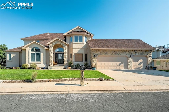 mediterranean / spanish-style house with a front yard and a garage